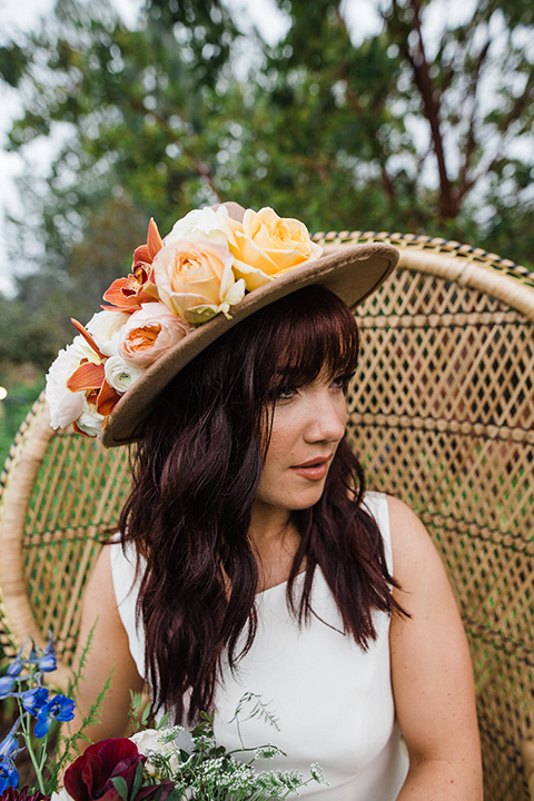 Los Robles Greens Shoot close up of bride with hat in a bohemian style dress with a high neckline and lace with a hat