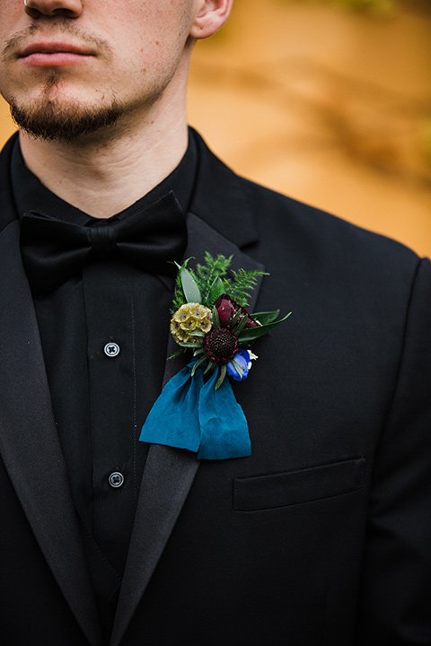 Los Robles Greens Shoot close up on groom in an all black tuxedo look with a black shirt and bow