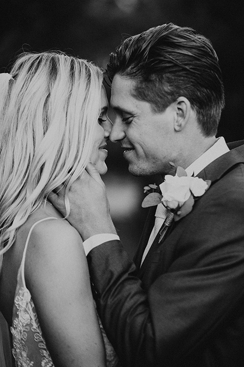 monarch-beach-resort-black-and-white-photo-close-up-of-bride-and-groom-bride-in-a-lace-dress-with-thin-straps-groom-in-a-grey-suit-with-ivory-long-tie