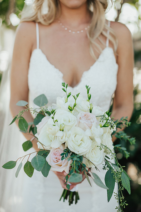 monarch-beach-resort-brides-flowers-bride-in-a-lace-dress-with-thin-straps-groom-in-a-grey-suit-with-ivory-long-tie