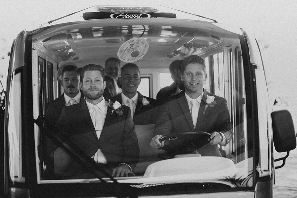 monarch-beach-resort-groom-driving-the-van-groom-in-a-grey-suit-with-ivory-long-tie