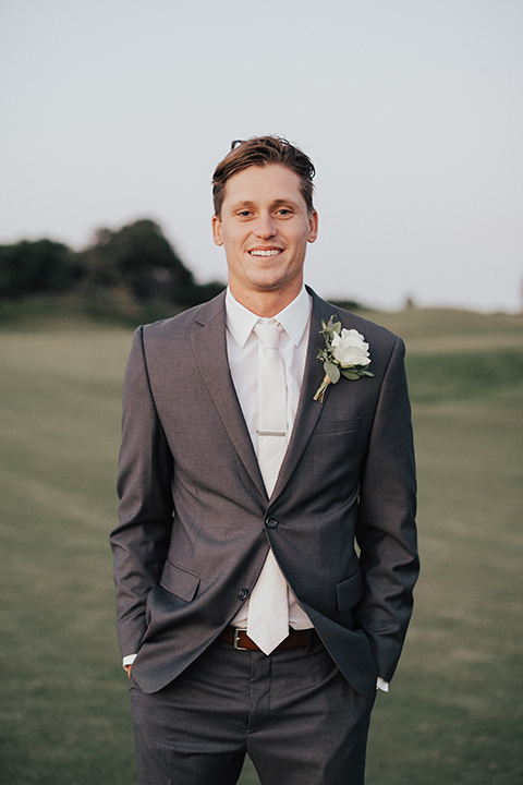 monarch-beach-resort-groom-standing-groom-in-a-grey-suit-with-ivory-long-tie