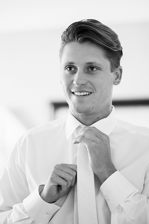 monarch-beach-resort-groom-without-jacket-groom-in-a-grey-suit-with-ivory-long-tie