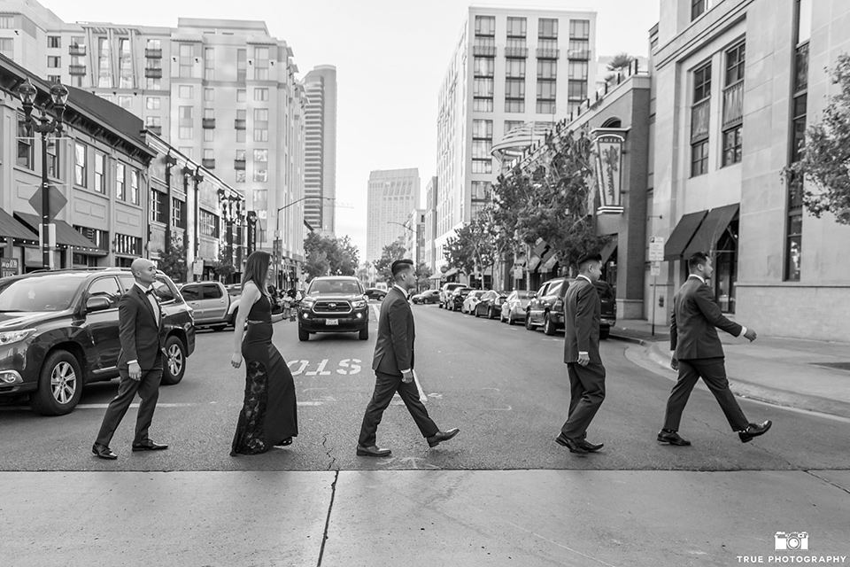 skybox-real-wedding-groomsmen-the-abbey-road-photo-bride-wearing-a-fitting-lace-dress-with=straps-groom-wearing-a-blue-suit-bridesmaids-in-burgundy-groomsmen-in-blue