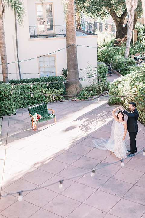 Maxwell-House-Shoot-bride-and-groom-dancing-bride-in-a-strapless-gown-with-an-illusion-bodice-groom-in-a-black-suit-with-a-black-long-tie