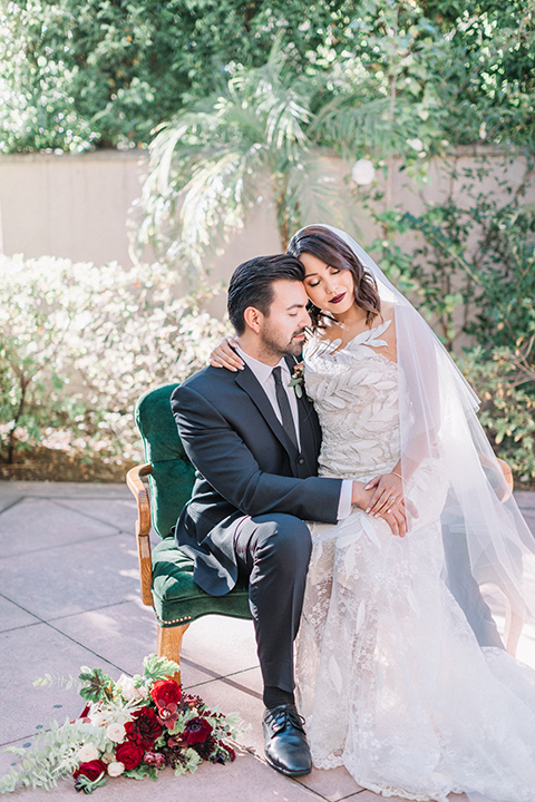 Maxwell-House-Shoot-bride-sitting-on-groom-lap-bride-in-a-strapless-gown-with-an-illusion-bodice-groom-in-a-black-suit-with-long-black-tie