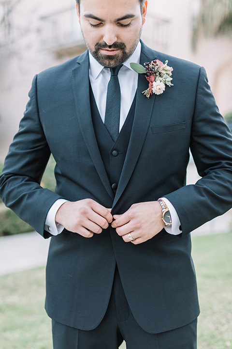 Maxwell-House-Shoot-groom-buttoning-jacket-in-a-black-suit-with-a-black-long-tie