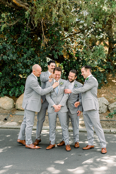 Temecula-Creek-Inn-Wedding-groomsmen-and-groom-in-a-light-grey-suit-with-blue-patterned-ties