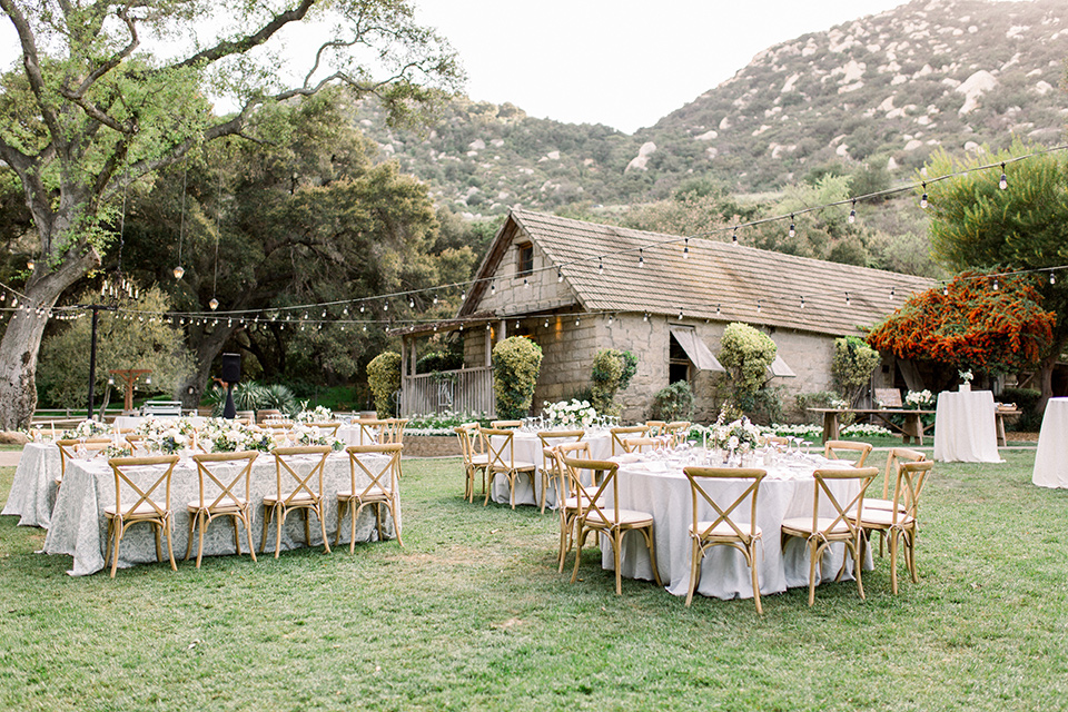 Temecula-Creek-Inn-Wedding-reception-area-with-wooden-tables-and-chairs-with-string-lights