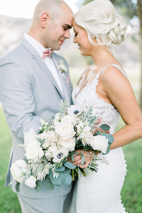 bride and groom touching foreheads for a photo