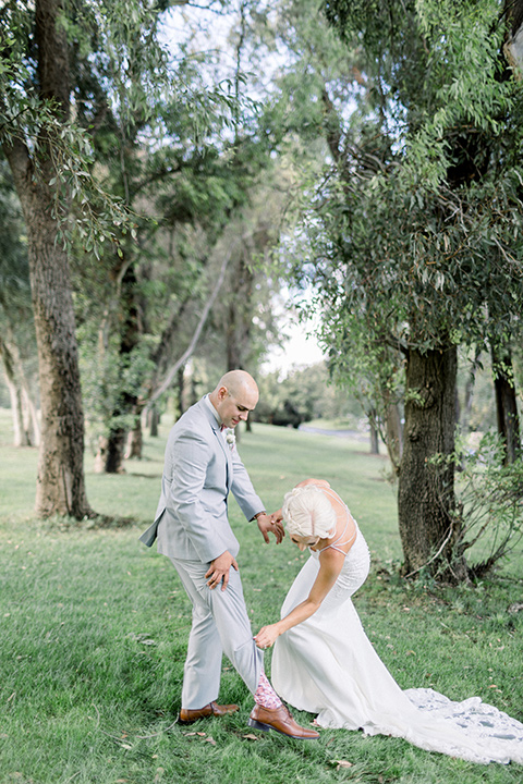 bride looking at groom's colorful socks