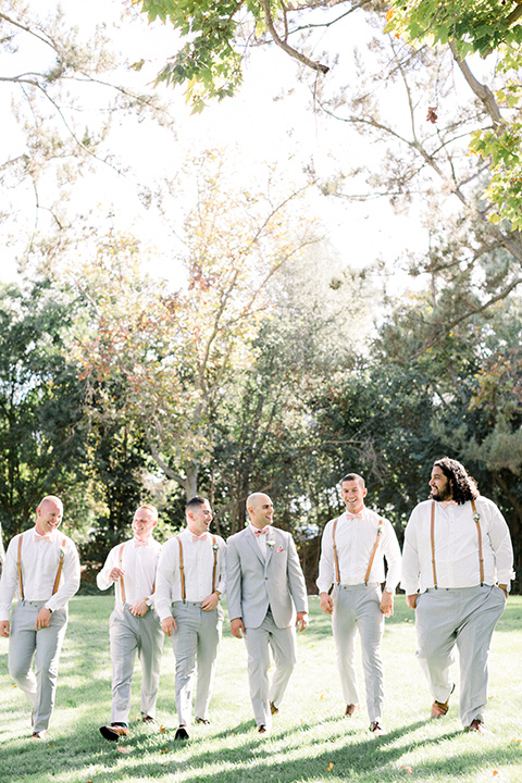 Groom and Groomsmen posing for a picture in suspenders