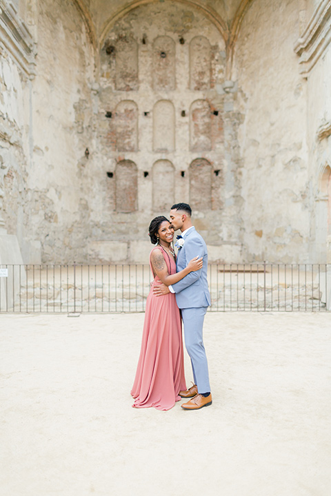  bridesmaid in a coral gown with a light blue suit