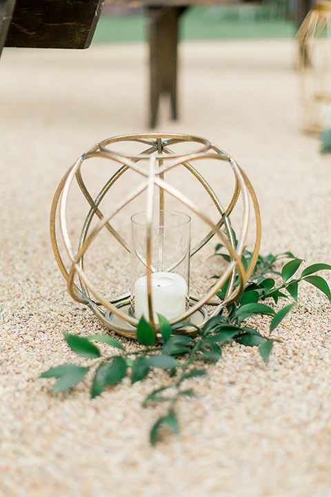  gold wire décor with white candles lining the ceremony aisle 