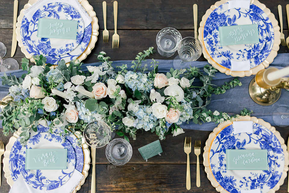  white and blue floral design on plates and gold flatware