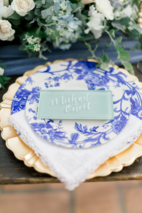  white and blue floral design on the plates and gold décor and flatware