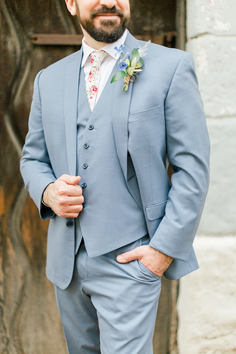  groom in light blue suit and white floral neck tie 