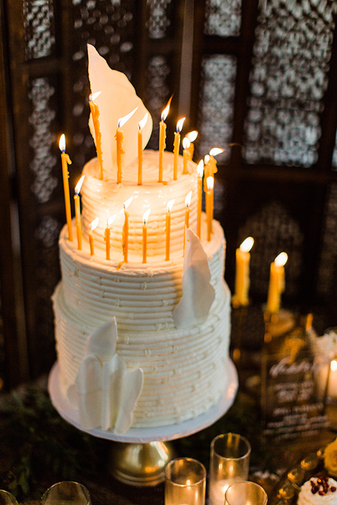 modern Moroccan shoot cake with white frosting and tall candles