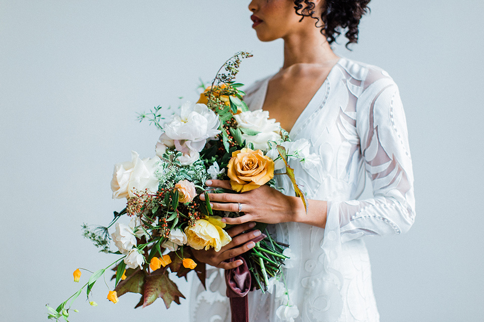 modern Moroccan shoot bride close up the bride in a white lace gown with long sleeves and a v neck line