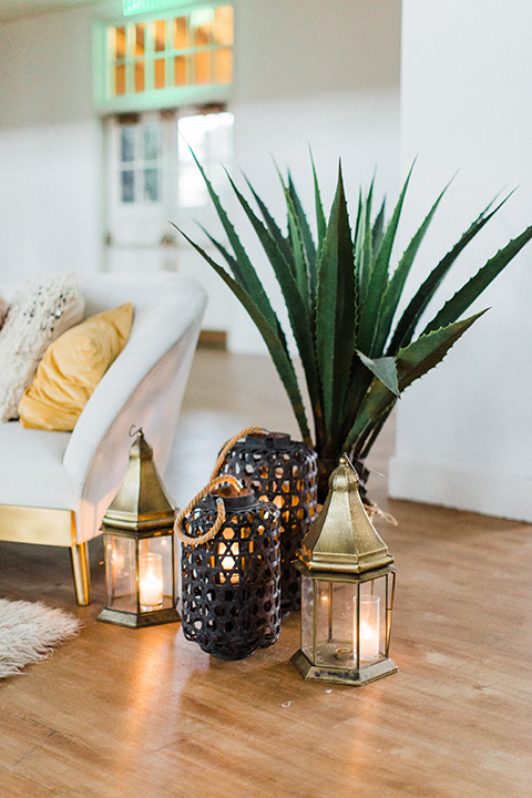 modern Moroccan shoot reception florals with palm leaves and gold vases