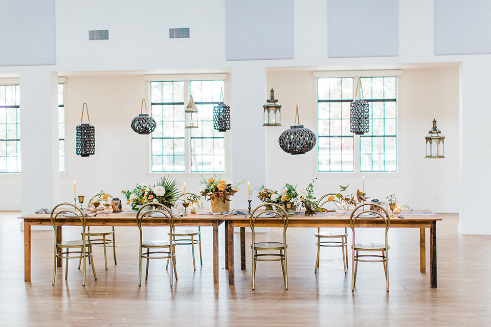  modern Moroccan shoot wooden table with gold accents and green florals 
