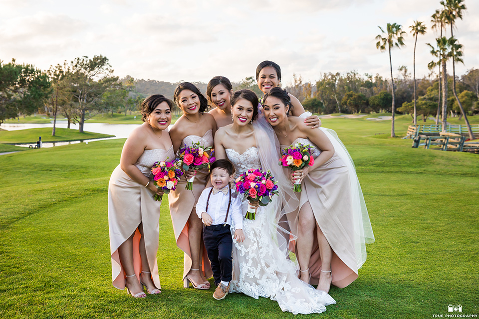 bride in a white lace strapless gown and bridesmaids in champagne colors gowns