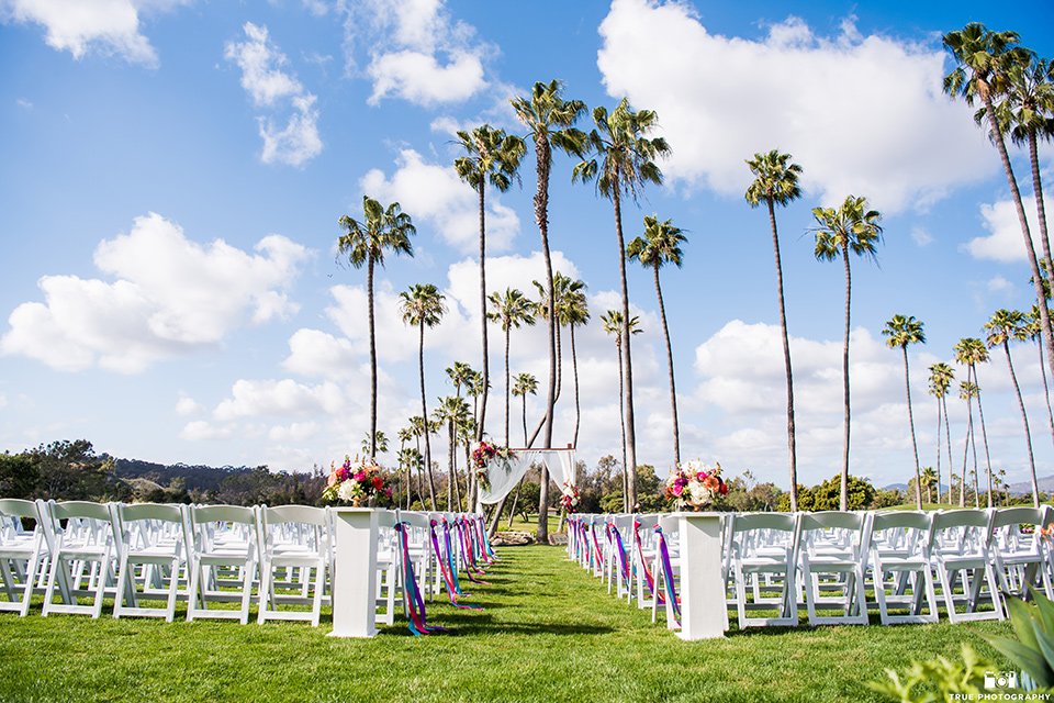 white chairs and colorful floral and ribbon accents