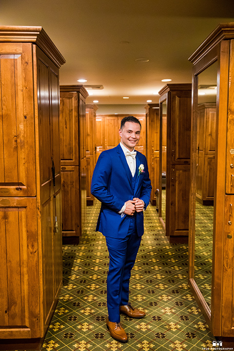  groom in a blue suit and bow tie 