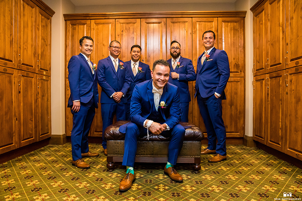 groom and groomsmen in blue suits and bow ties