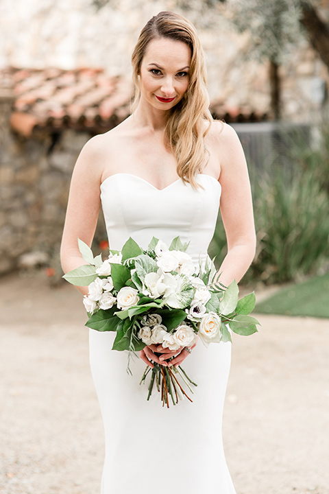 Oak Meadows shoot with bride holding in a strapless trumpet wedding gown