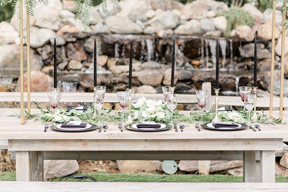 Oak Meadows table set up with a white wooden table and flowers