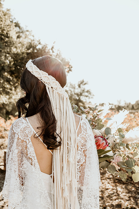 Owl-Creek-Farms-shoot-brides-macrame-headpiece-bide-in-a-flowing-boho-gown-with-sleeves