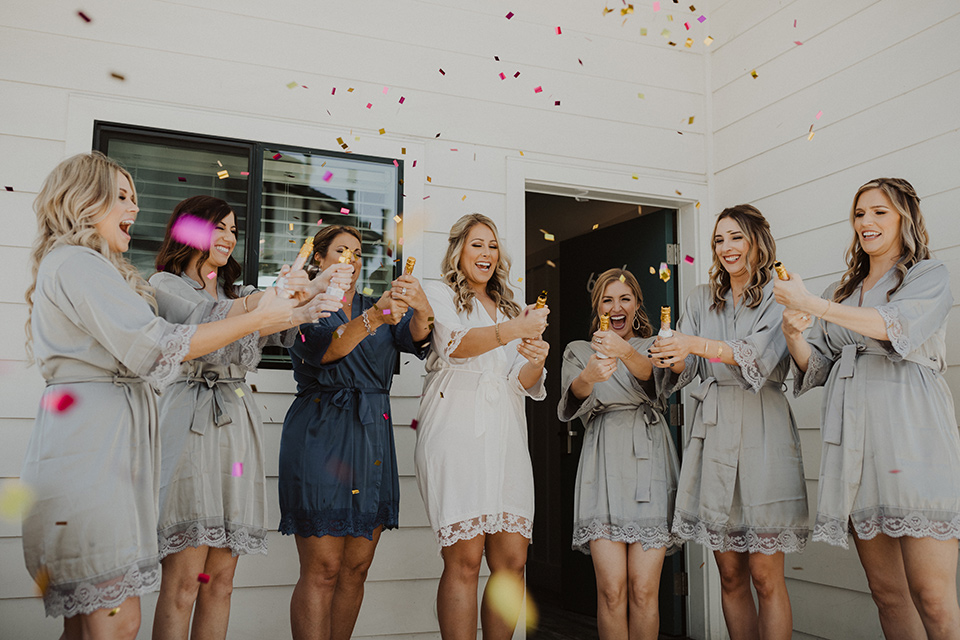 bridesmaids-and-bride-in-robes-and-confetti
