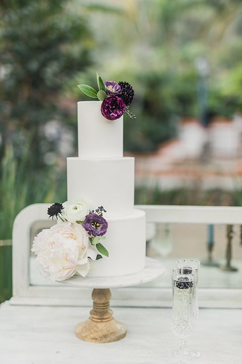 rancho-las-lomas-wedding-cake-with-white-fondant-and-purple-flowers