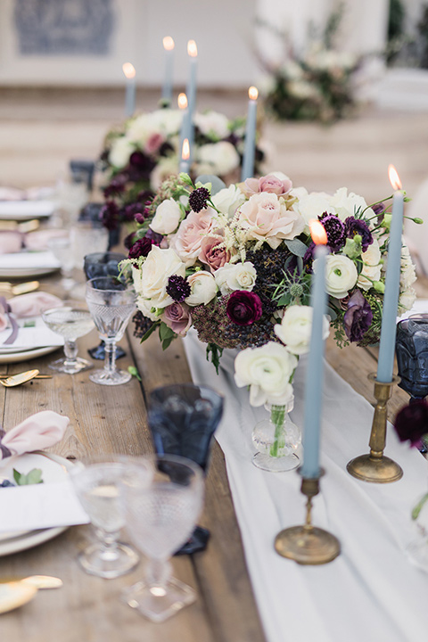 rancho-las-lomas-wedding-close-up-on-table-décor-with-blue-candles-and-purple-flowers