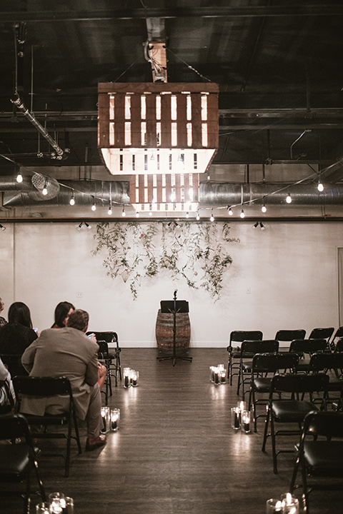 Moniker-Warehouse-Wedding-ceremony-set-up-in-an-industrial-sace-with-concrete-flors-and-dark-lighting-with-romantic-candles-everywhere