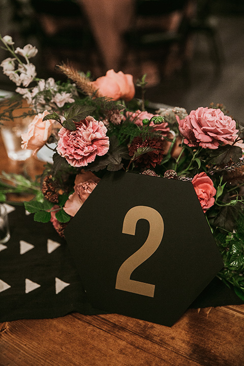 Moniker-Warehouse-Wedding-table-décor-with-black-numers-with-gold-geometric-design-and-pink-linens