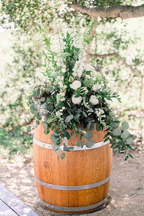 Circle-Oak-ranch-wedding-ceremony-décor-with-flowers-in-wine-barrels