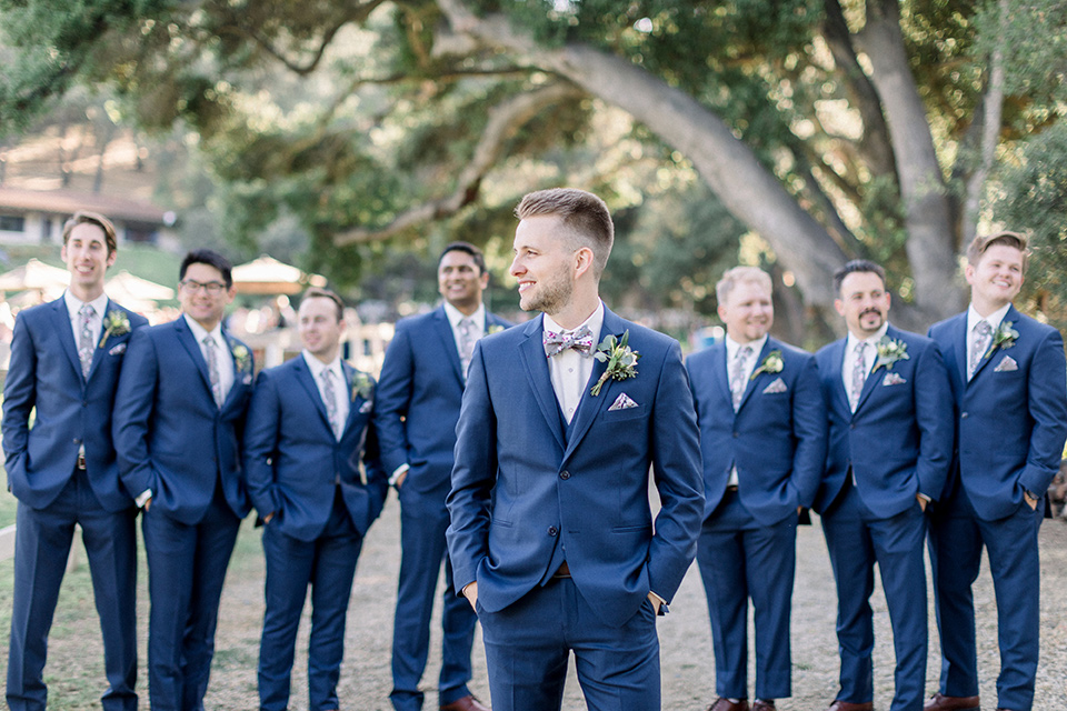 Circle-Oak-ranch-wedding-groomsmen-standing-in-cobalt-suits-and-floral-ties