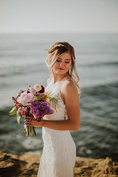 Sunset-Cliffs-Elopement-bride-looking-over-shoulder-in-a-lace-white-gown-with-thin-straps