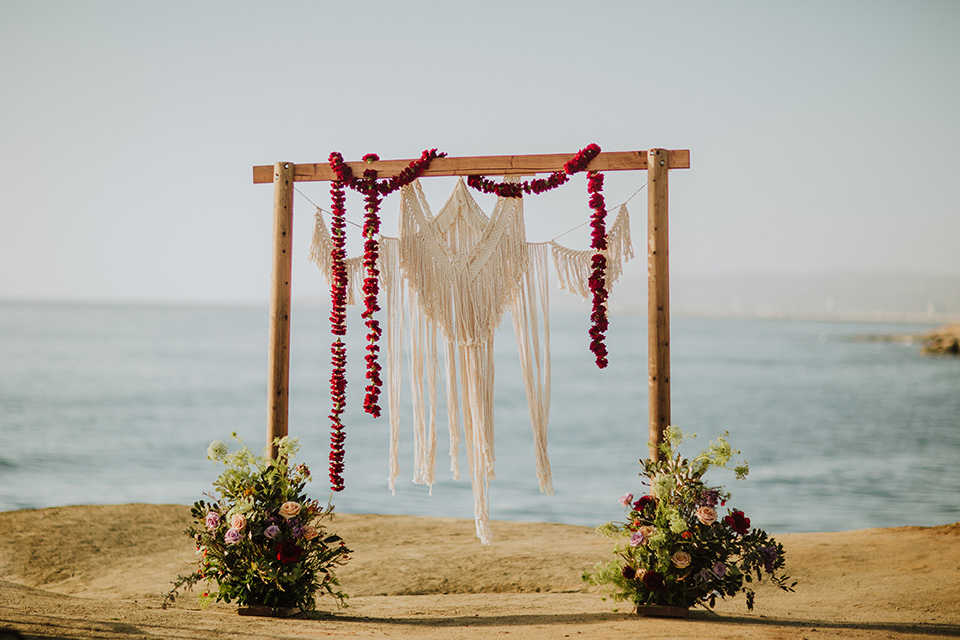 Sunset-Cliffs-Elopement-ceremony-arch-with-wood-and-hanging-floral-design