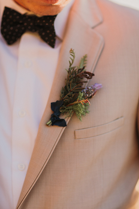 Sunset-Cliffs-Elopement-groom-attire-up-close-in-a-tan-suit-coat-with-black-pants-and-black-bow-tie