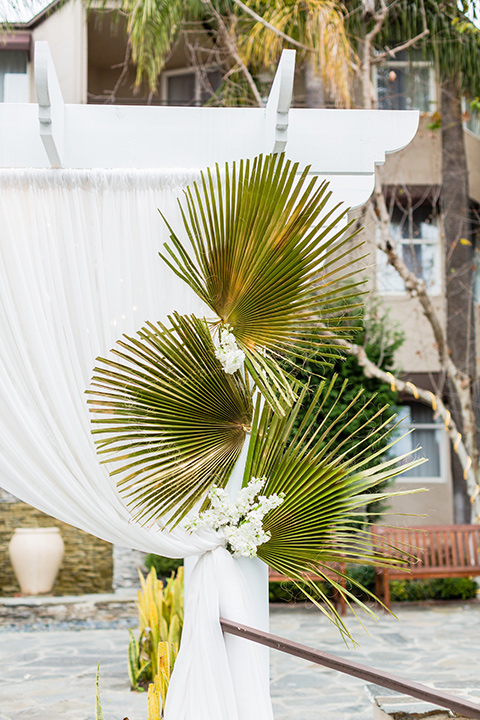 Belamar hotel wedding ceremony details with palm leaves and white and gold details 
