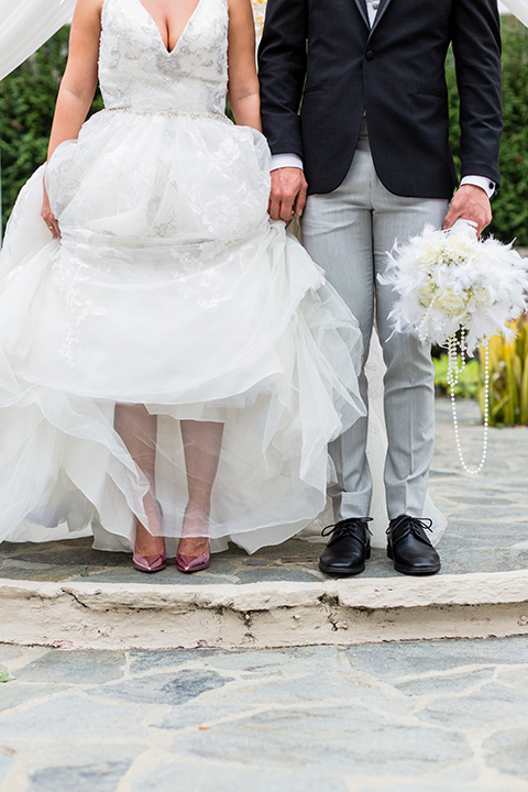 close up on footwear of bride and groom while in wedding shoes and attire