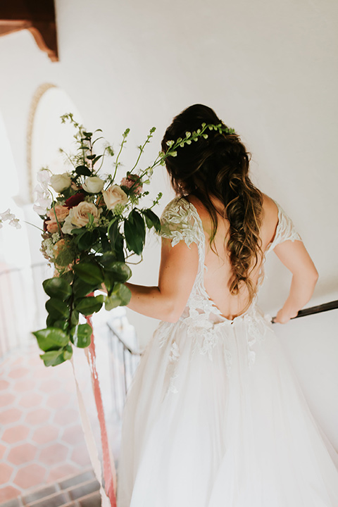 bride in a lace gown with a cap sleeve and illusion neckline