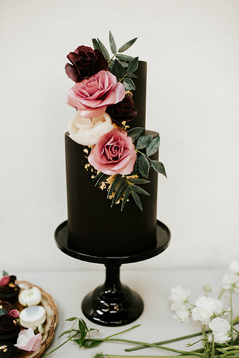 black two-tier cake with pink florals