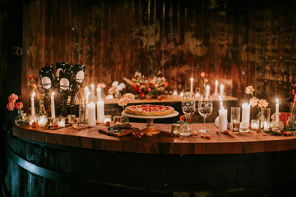 wooden table with candles and desserts