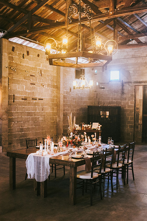 wooden table and white linens and candles in the wine cellar