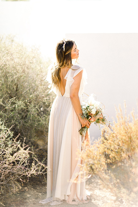 Bride in a cream and ivory flowing gown with a gold headband with stars