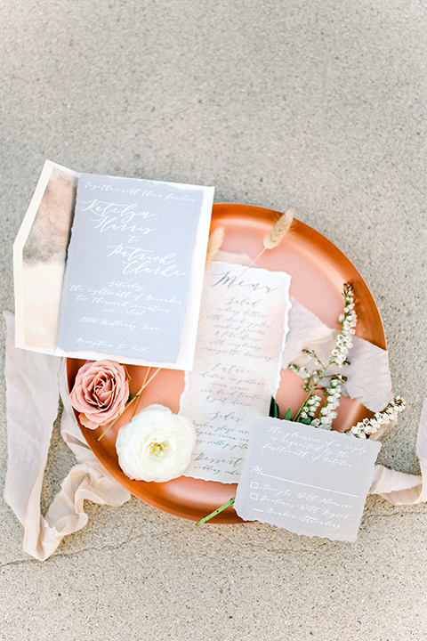 White and terracotta colored invitations